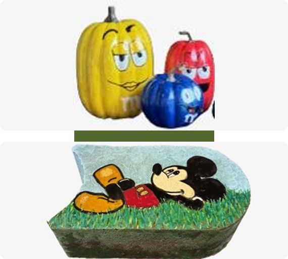 Three colorful pumpkin characters and a Mickey Mouse-shaped cake.